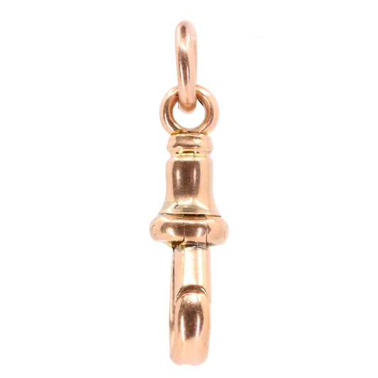 A polished rose gold pendant charm shaped like a miniature bell or bell-shaped ornament, suspended from a fine wire against a plain white background.