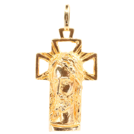 A gold Jesus head pendant on a cross, shown against a plain white background.
