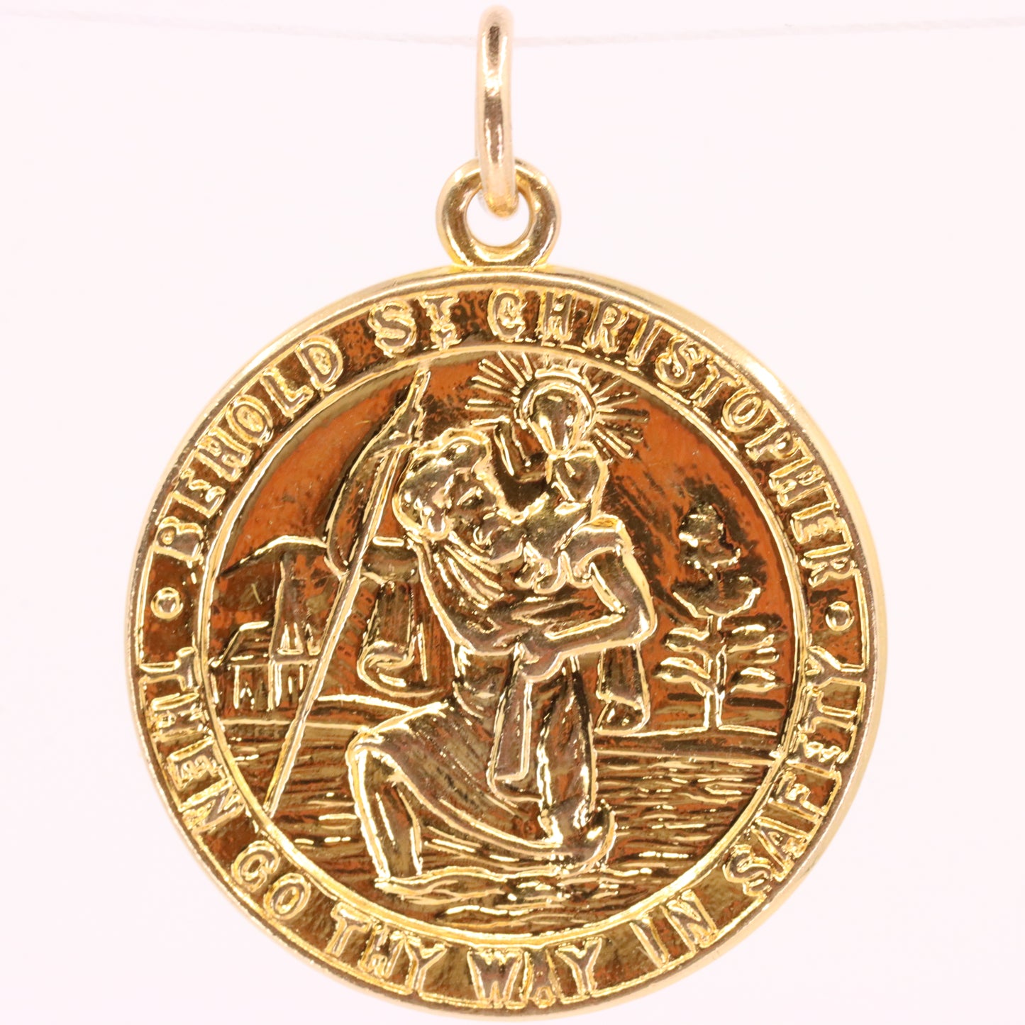 A round gold Saint Christopher medal pendant with a polished bail, featuring an embossed depiction of Saint Christopher carrying the Christ child across water, set against a plain white background.