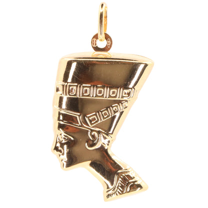 A gold pendant shaped like the profile of Queen Nefertiti, featuring detailed engravings on her headdress, shown against a plain white background.
