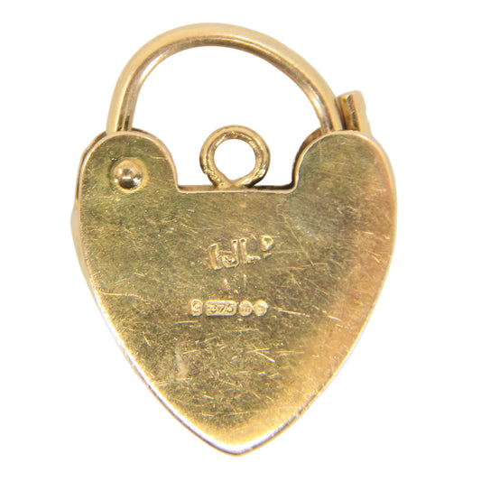 A small heart-shaped gold pendant or charm with a hinged clasp and loop at the top, photographed on a plain white background.