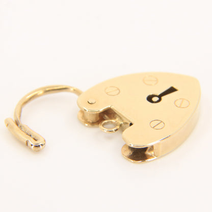 A small gold-toned metal padlock with a curved shackle and a small black keyhole cutout, photographed on a plain white background.